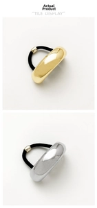 Detailed comparison of gold and silver metallic U-shaped hair ties on black elastic bands