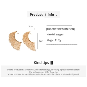 Detail view of golden beaded tassel earrings made of copper with size and weight specs