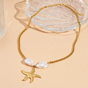 Macro detail of starfish pendant and baroque pearls on a gold-plated ocean-inspired necklace