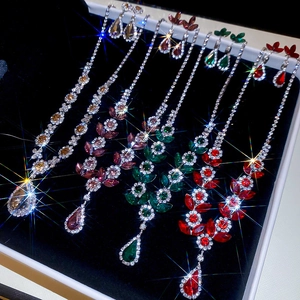 Detailed close-up of crystal flower jewelry set with colorful gemstones in a black box