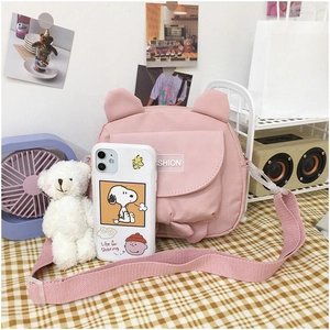 Pink canvas crossbody bag featuring cute cat ears and a front pocket with fashion label