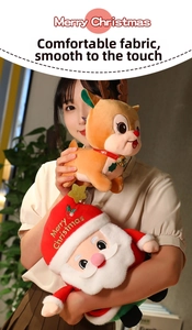 Close-up of plush Santa and reindeer dolls with Merry Christmas embroidery held by a model