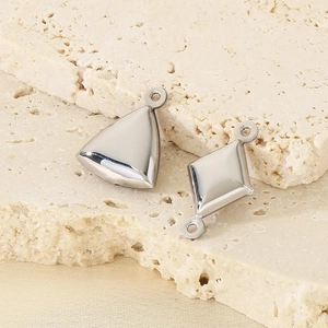 Detailed macro view of polished silver geometric hollow pendant and diamond connector