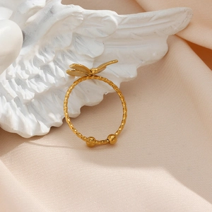 Detail of 18K gold plated butterfly ring with twisted band on white wing sculpture