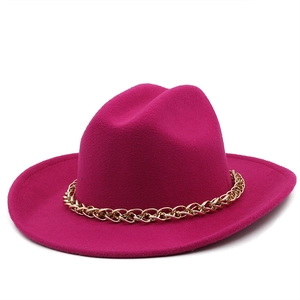 Detail of fuchsia wool fedora hat featuring a stylish chunky gold chain band accessory