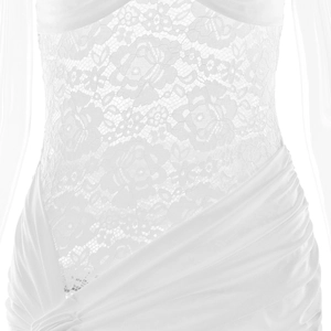 Close-up of white dress with intricate lace patterns and elegant waist pleats