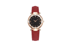 Close-up of starry sky dial with Roman numerals and faceted glass on a red leather watch