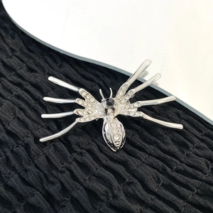 Gothic silver spider brooch with sparkling rhinestones and a black stone center