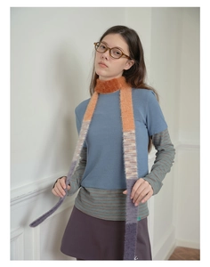 Detail of soft faux mink fur scarf with vibrant orange to purple gradient on female model