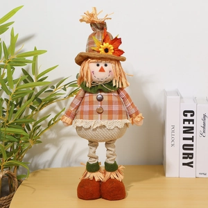 Detail of harvest scarecrow doll with orange plaid fabric and sunflower accents