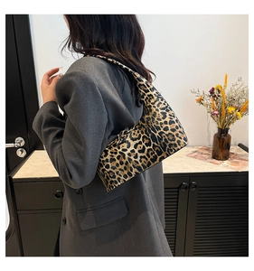Leopard print bucket bag shown on model in a stylish grey blazer for daily outfit