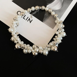 Detailed shot of irregular pearl cluster necklace with silver beads and lobster clasp