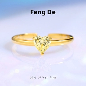 Detail of a heart-shaped yellow gemstone ring with adjustable S925 silver band