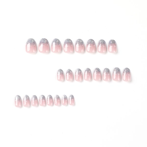Pink gradient press-on nails with silver glitter French tips and white star patterns