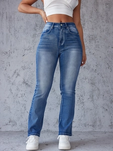 Detail shot of vintage washed blue denim jeans with high waist and whiskered texture