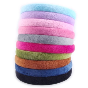 Set of 10 colorful plush fabric headbands in assorted pastel and neutral tones on white