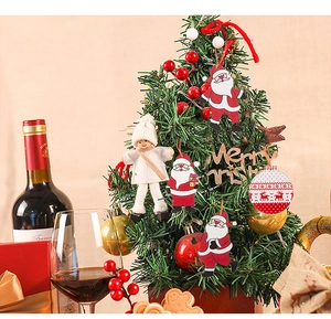 Close-up of red and white Christmas tree ornaments including Santa and plush doll figures