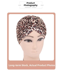 Detail showing leopard print pleated turban with cross knot design on soft knit fabric