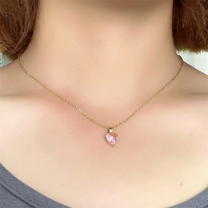 Close-up of heart-shaped pink zircon pendant with gold plated stainless steel chain