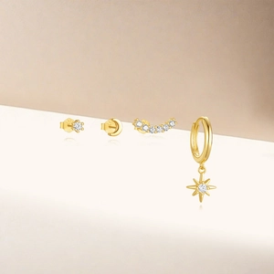 Detail of 925 silver gold-plated earring set featuring star moon and zircon studs