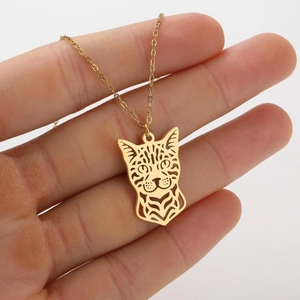 Close-up of golden hollow cat head pendant necklace with minimalist o-chain