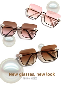 Detailed view of fashion sunglasses with gradient lenses and decorative pearl accents