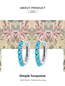 Detailed macro view of S925 silver hoop earrings featuring blue turquoise bead stones