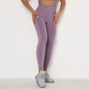 Detail of high-waisted seamless purple yoga pants with sweat-wicking knit texture