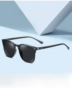 Close-up of black polarized sunglasses with high-gloss frame on a blue background