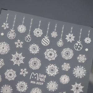 White Christmas embossed nail stickers featuring snowflakes and ornaments on dark grey base
