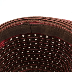 Close-up of breathable hollow weave straw hat with sweatband and red stitching