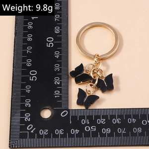 Detail view of acrylic butterfly keychain with gold ring weighing 9.8g for bags