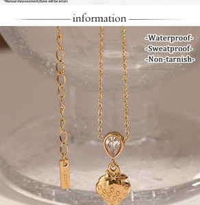 Close-up of golden strawberry pendant necklace on glass with waterproof feature details