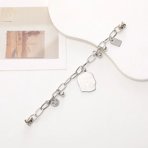 Silver metal chain bracelet with Good Luck square tags and smiling face charms