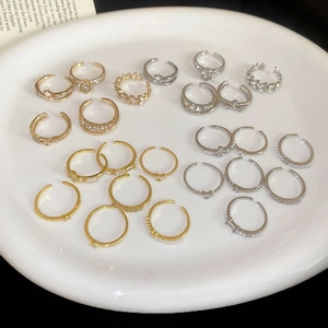 Detailed top-down view of luxury ring set with zircons and pearls in a white ceramic dish