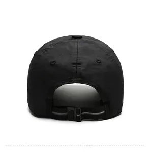 Detail view of the adjustable rear strap with silver stripe on a black sport cap