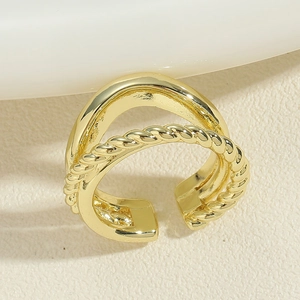 Detailed close-up of a golden double-layered wave ring with twisted rope texture and polished finish