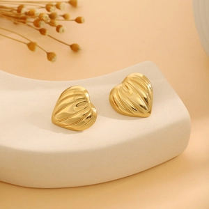 Golden heart-shaped stud earrings with vintage pleated texture and luxury metal finish