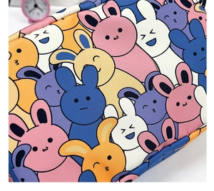 Close-up of durable canvas material featuring colorful cartoon bunny pattern prints