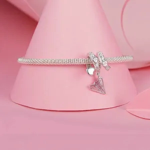 Sterling silver mesh bracelet with pink enamel paper plane charm and crystal accents