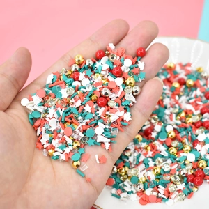 Close-up of Christmas themed slime charms and polymer clay slices in various shapes