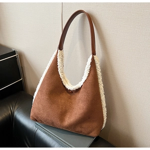 Detail of contrast tote bag featuring brown suede texture and white faux fur trimming