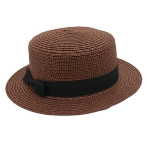 Detailed view of dark brown woven boater hat featuring a black ribbon bow decoration