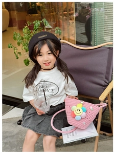Girl wearing white cotton T-shirt and pink woven flower bag with pearls