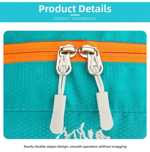 Detail of durable dual zipper on teal ripstop fabric for hiking backpack