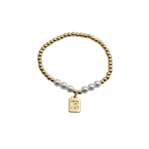 Detail of beaded bracelet with gold beads, pearls and letter E engraved pendant