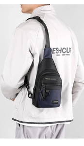 Rear view of a model wearing the blue and black nylon crossbody chest bag for men