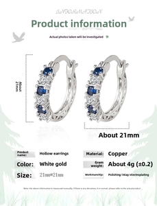 Detailed view of hollowed-out platinum-plated earrings with blue and white zircons