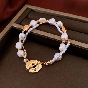 Vintage style double-layered baroque pearl bracelet with golden toggle clasp and branch texture