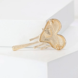 Golden fluid heart brooch with artistic melting design and secure pin closure back